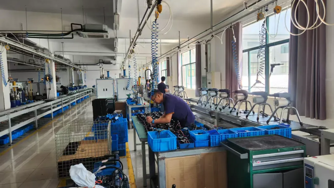 High-capacity assembly operations inside an OEM coating equipment production line facility producing 100,000 units annually.
